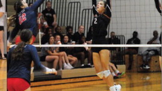 Hutto High School varsity volleyball senior Cori Babb (2) goes up to block a shot at the net on Aug. 29 during the Lady Hippos’ home match victory over Georgetown East View High School. Photo by Larry Pelchat