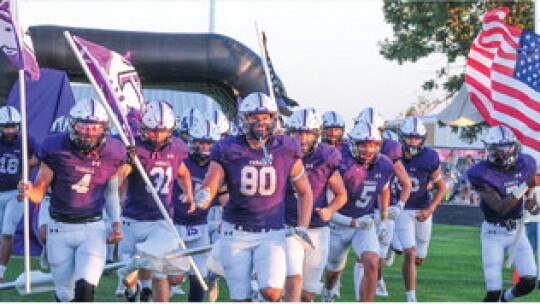 The Thrall High School varsity football team runs onto the field prior to the Tigers’ game on Sept. 8 vs. Florence High School. Photo by Larry Pelchat